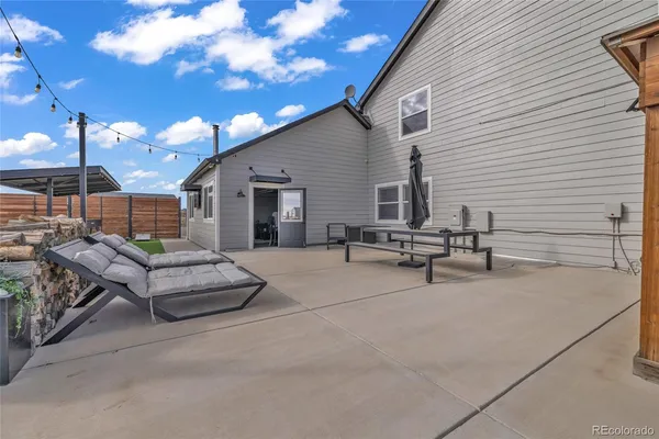 a view of a patio with couches and table and chairs