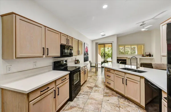 a kitchen with a sink stove and microwave