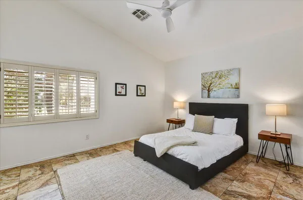 a bedroom with a large bed and a table