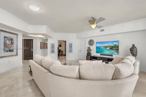 a living room with furniture and large windows