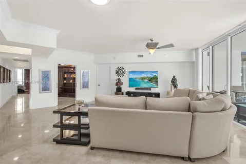 a large living room with stainless steel appliances kitchen island granite countertop furniture and a large window