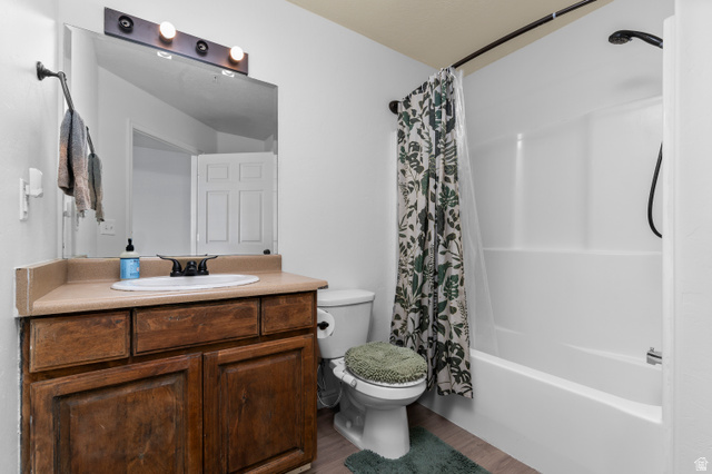25 West Ridge Road, Unit 25 Saratoga Springs, UT 84045 - Photo 13 of 22 Bathroom featuring a white integrated tub and shower unit, wood-finish flooring, a vanity with a light-colored countertop, and a built-in wood vanity cabinet