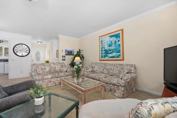 a living room with furniture a clock and a window