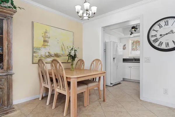 a view of a dining room with furniture and a chandelier