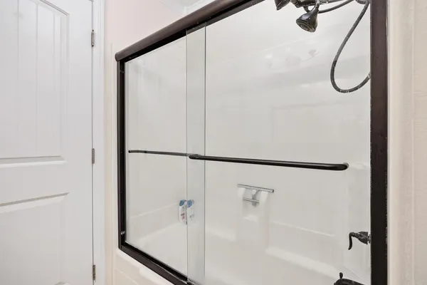 a bathroom with a glass shower door