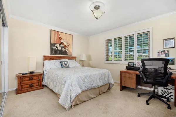 a bed room with a bed and a chair