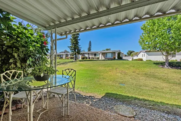 a view of a chairs and table in the patio