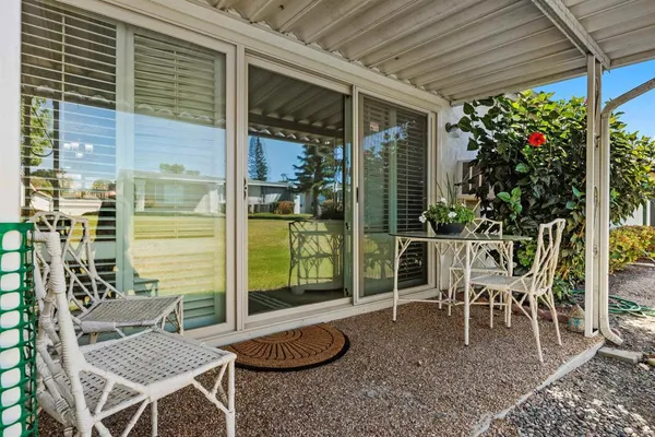 a view of a patio with table and chairs and potted plants
