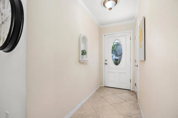 a view of a hallway with wooden floor and a bathroom