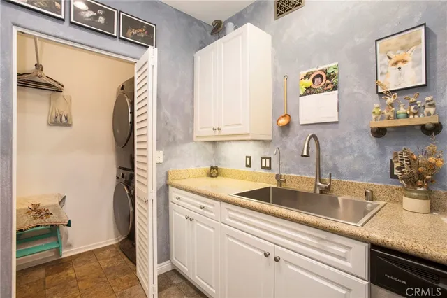 a kitchen with a sink and a refrigerator