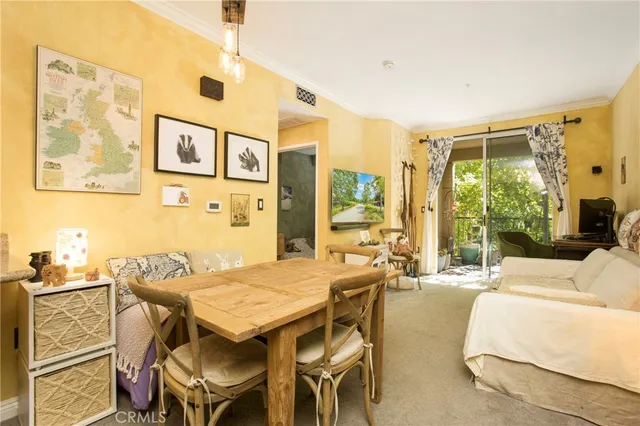 a view of a dining room with furniture large windows and wooden floor