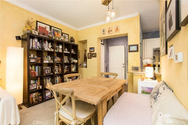 a view of a dining room with furniture and a book shelf