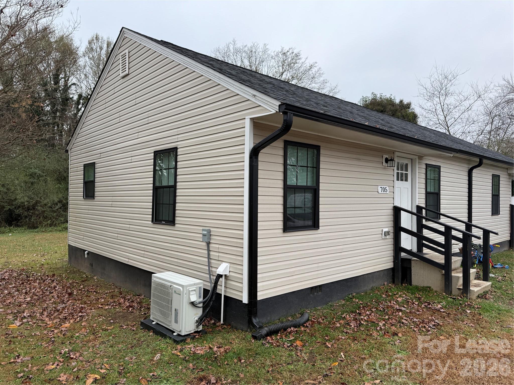 705 North Main Street Stanley, NC 28164 - Photo 2 of 10 a view of a white house with a white roof and a lawn chairs