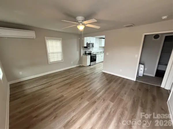 a view of a kitchen with wooden floor and a kitchen