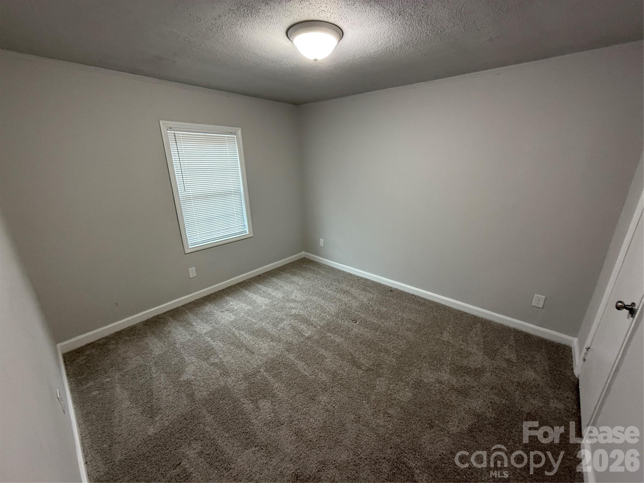 705 North Main Street Stanley, NC 28164 - Photo 7 of 10 an empty room with a window