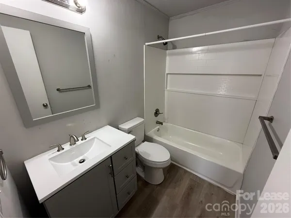 a bathroom with a sink mirror toilet and bathtub