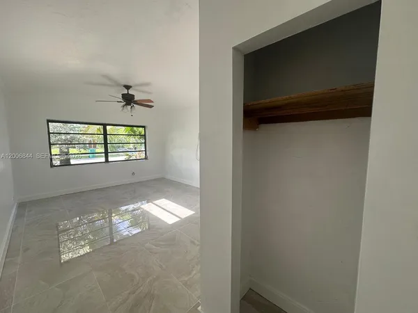 a view of an empty room and a window