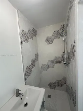 a bathroom with a sink and shower