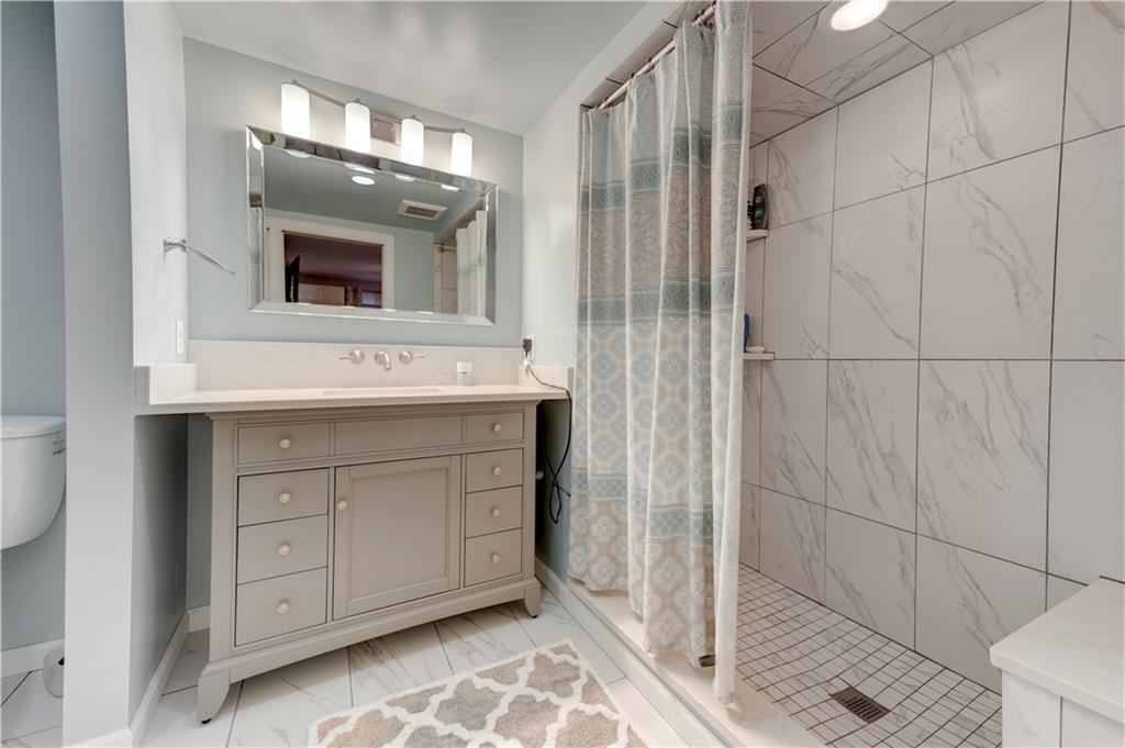 5618 Aiken Road McKees Rocks, PA 15136 - Photo 13 of 22 a bathroom with a sink and a mirror