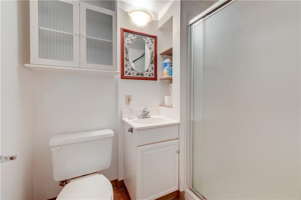 5618 Aiken Road McKees Rocks, PA 15136 - Photo 20 of 22 a bathroom with a toilet sink vanity and mirror