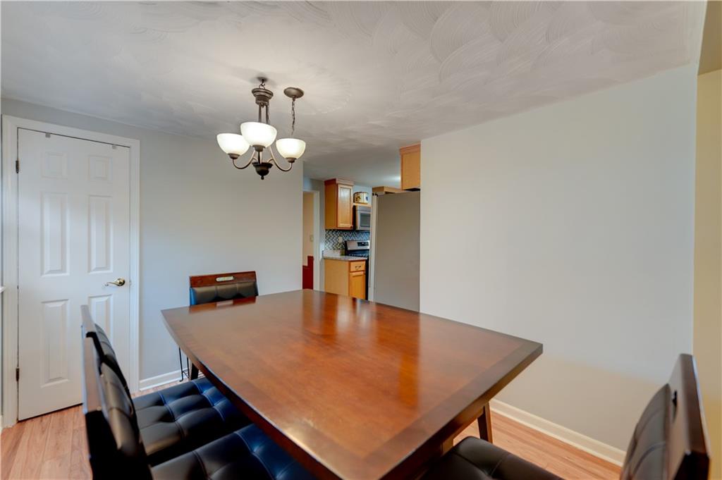 5618 Aiken Road McKees Rocks, PA 15136 - Photo 7 of 22 a view of a dining room with furniture and wooden floor