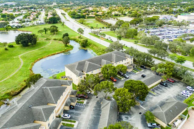 an aerial view of residential houses with outdoor space and street view