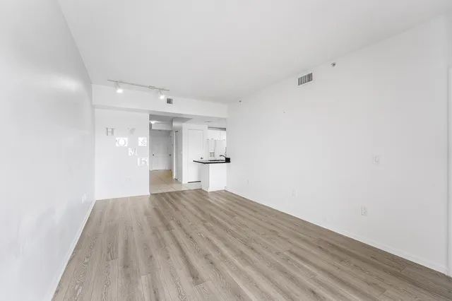 a view of wooden floor and windows in a room
