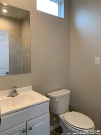 a bathroom with a sink a toilet and vanity