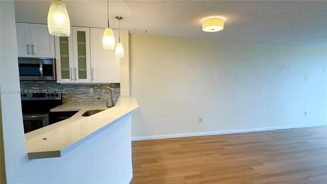 a kitchen with a sink and cabinets