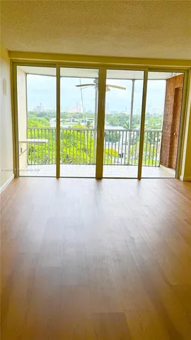 a view of an empty room with a large window