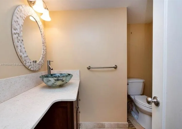 a room with a sink and a mirror