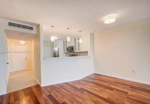 a view of a kitchen with wooden floor