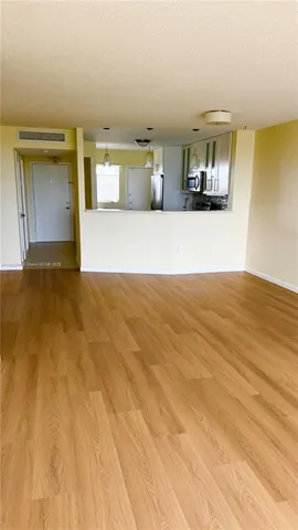 a view of a kitchen with a sink and a refrigerator