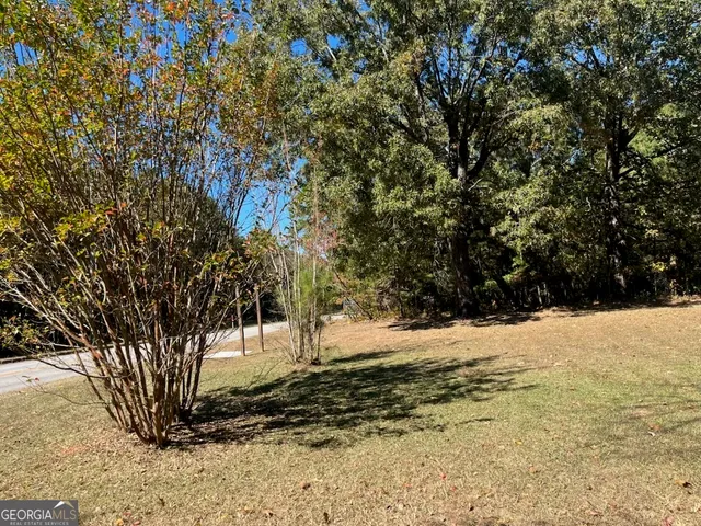 a view of a yard covered with snow in front of house