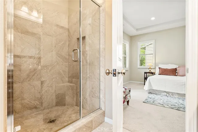 a spacious bedroom with a bed and a couch