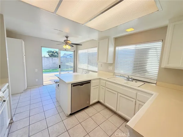 a kitchen with stainless steel appliances granite countertop a sink and a stove
