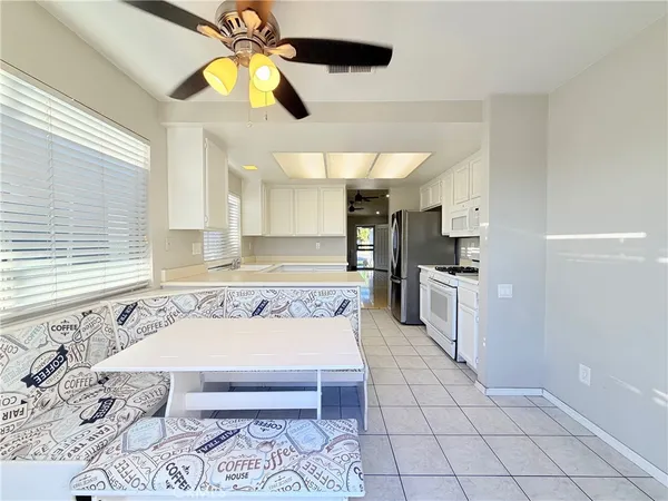 an empty room with closet and a ceiling fan