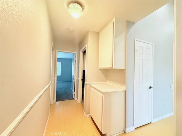 an empty room with a window and a ceiling fan