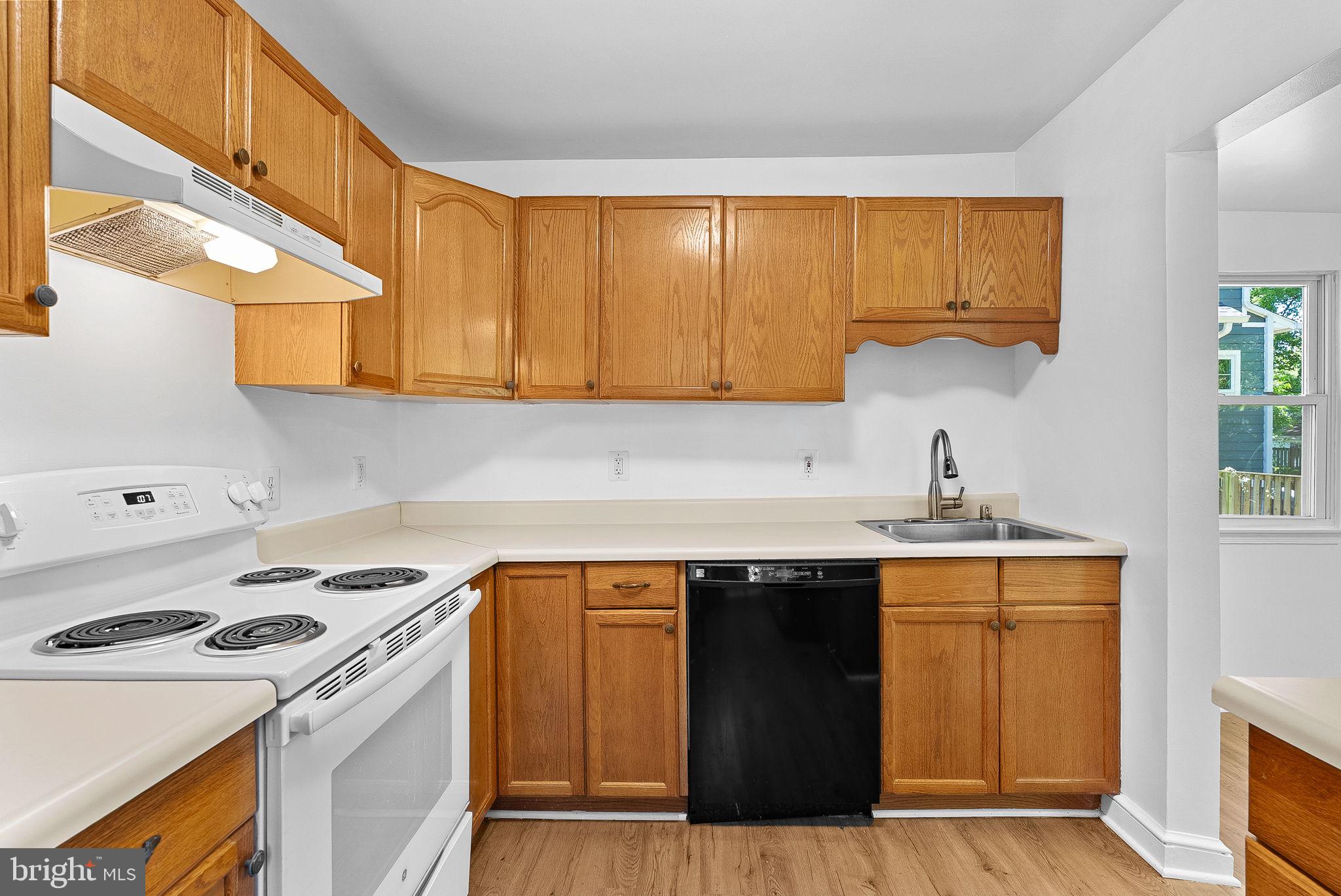 3103 Plyers Mill Road Kensington, MD 20895 - Photo 12 of 32 a kitchen with a sink a stove and a refrigerator