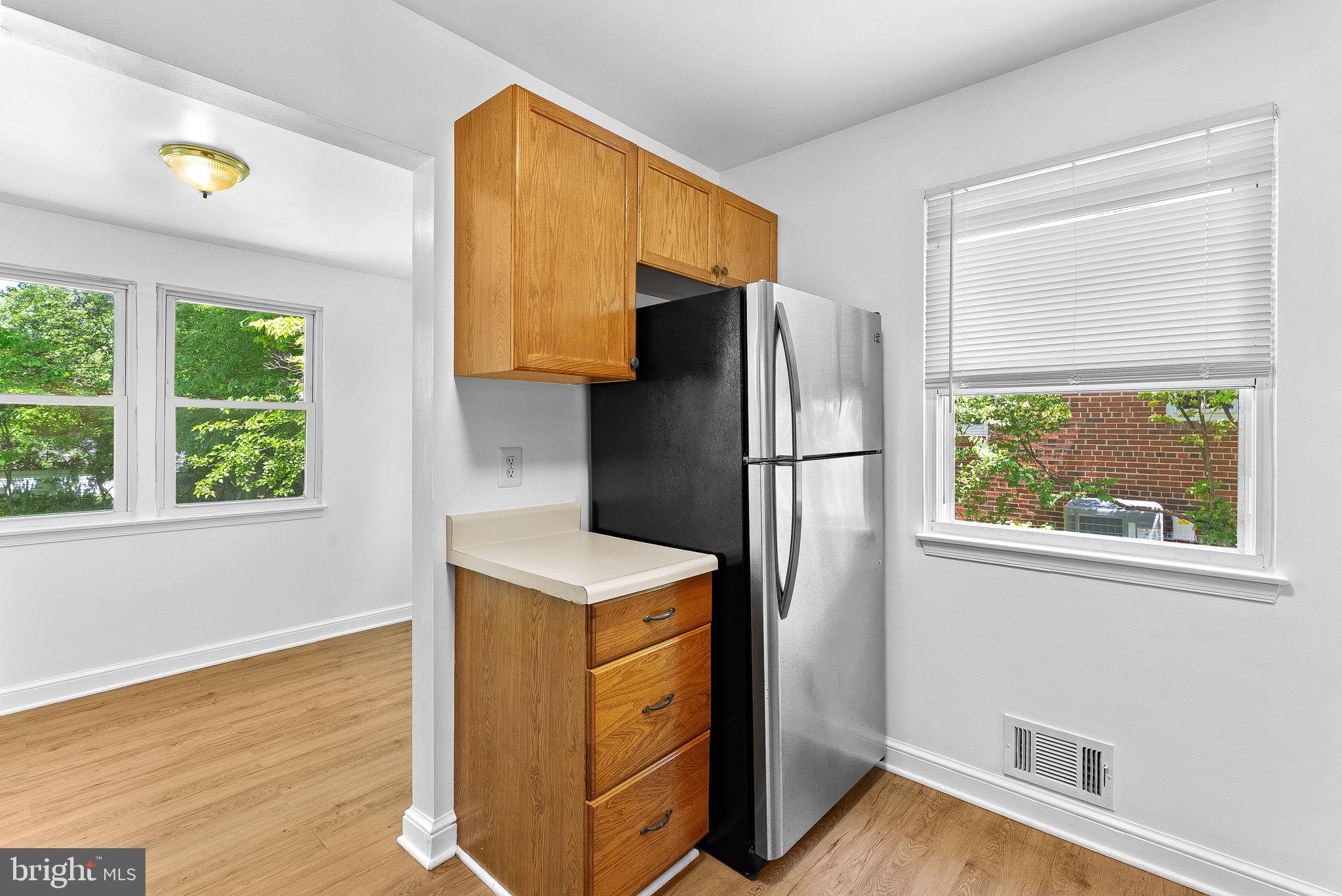 3103 Plyers Mill Road Kensington, MD 20895 - Photo 14 of 32 a kitchen with stainless steel appliances a refrigerator and a window
