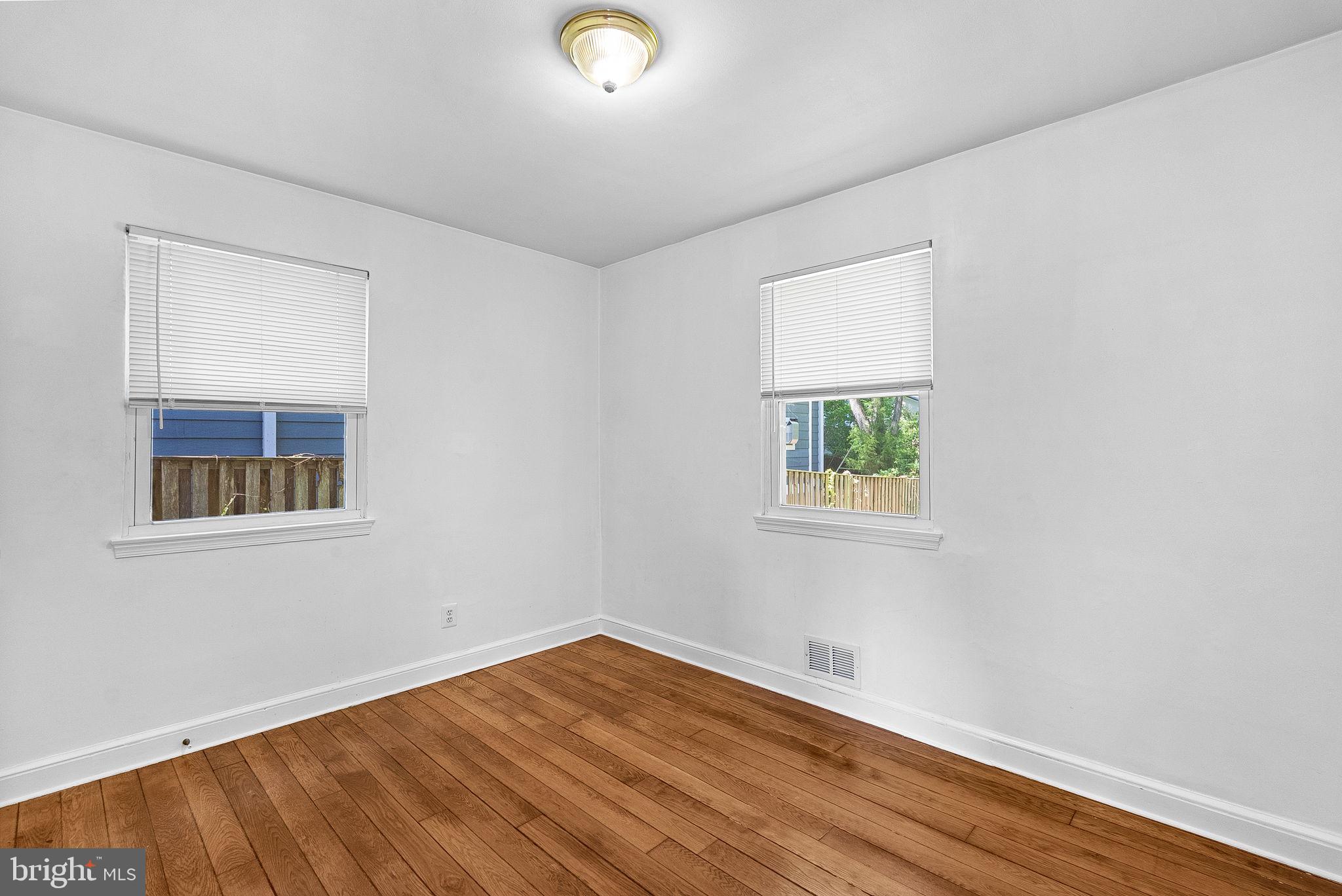 3103 Plyers Mill Road Kensington, MD 20895 - Photo 15 of 32 an empty room with wooden floor and windows