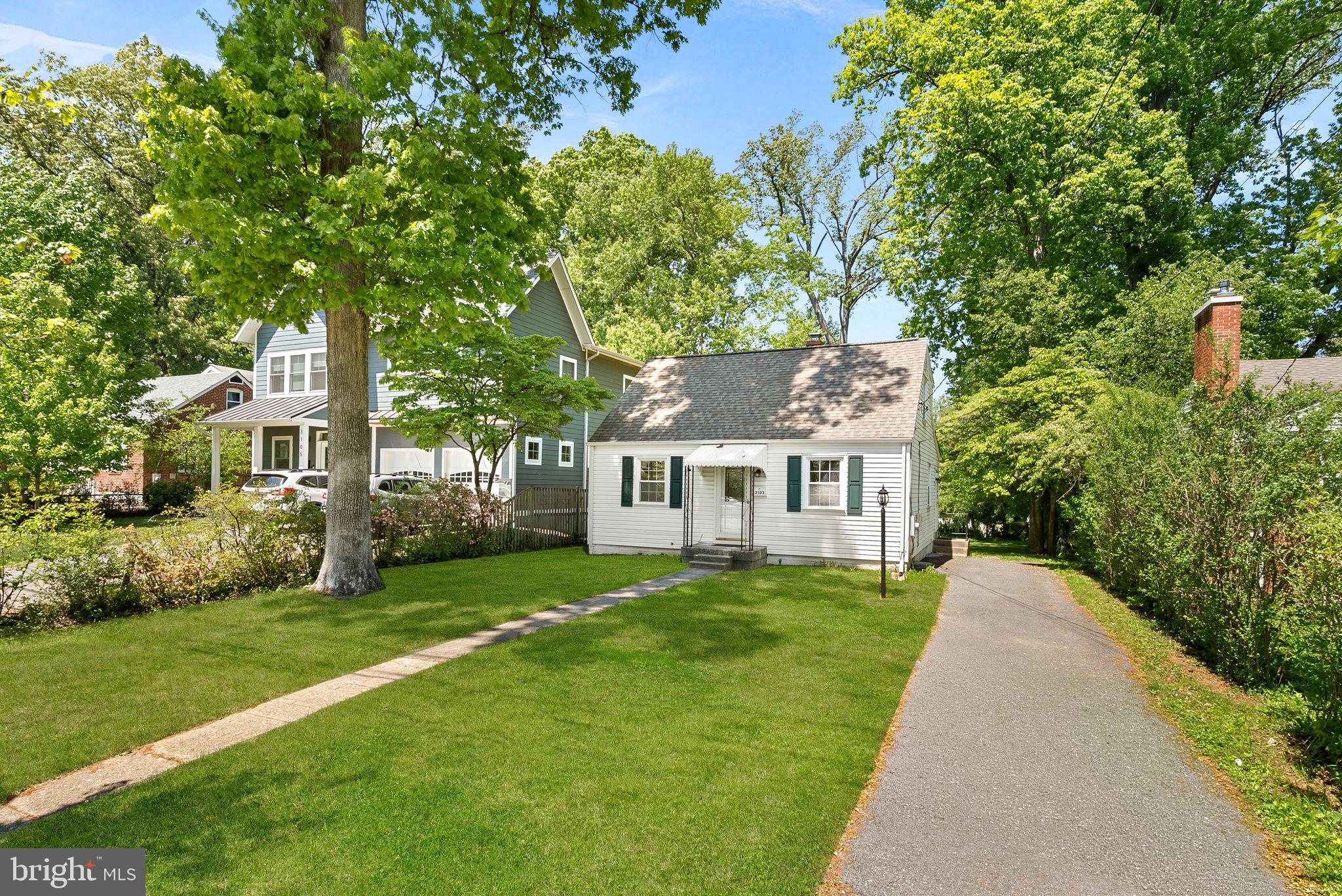3103 Plyers Mill Road Kensington, MD 20895 - Photo 2 of 32 a front view of a house with a yard and trees
