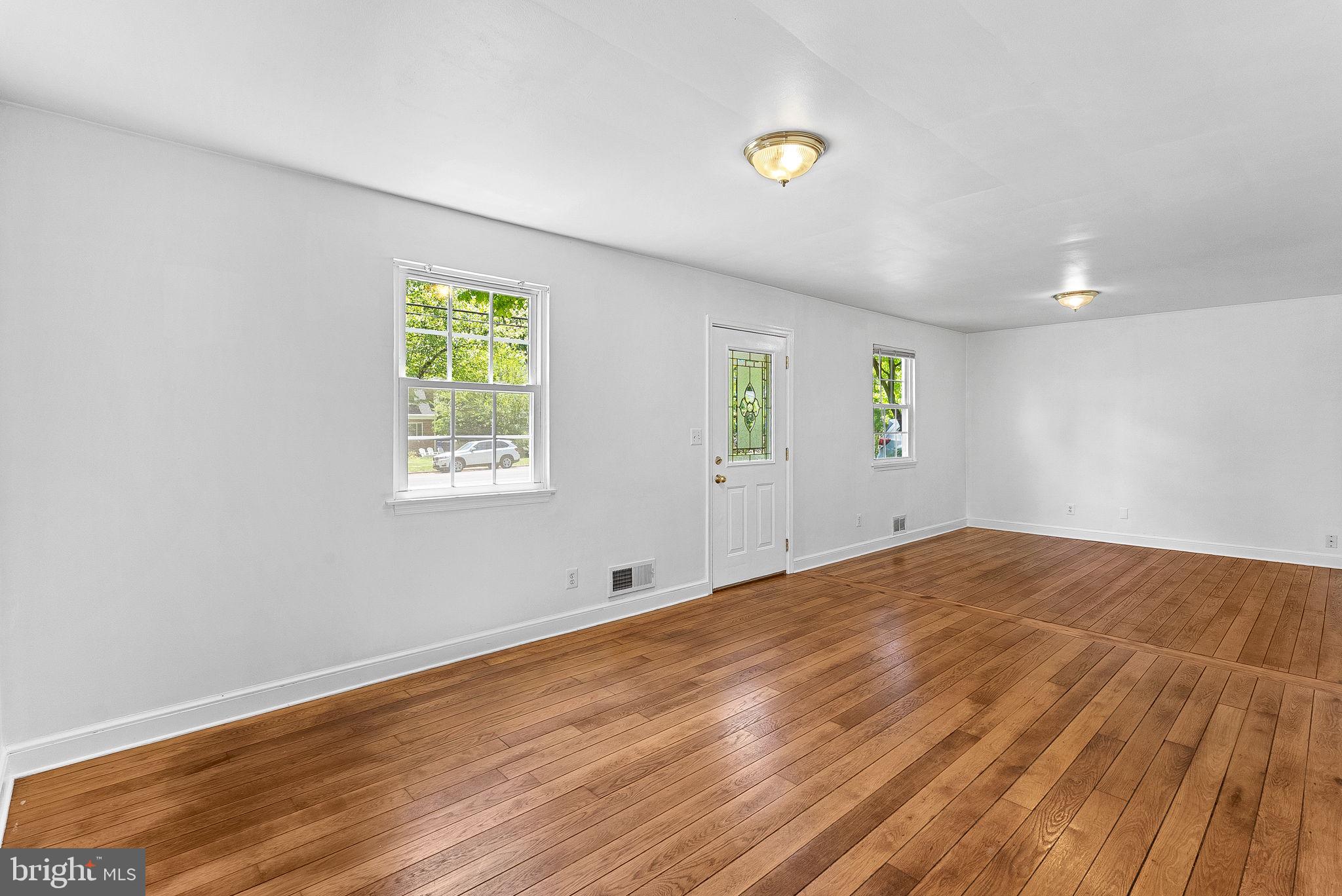 3103 Plyers Mill Road Kensington, MD 20895 - Photo 5 of 32 a view of empty room with wooden floor and fan