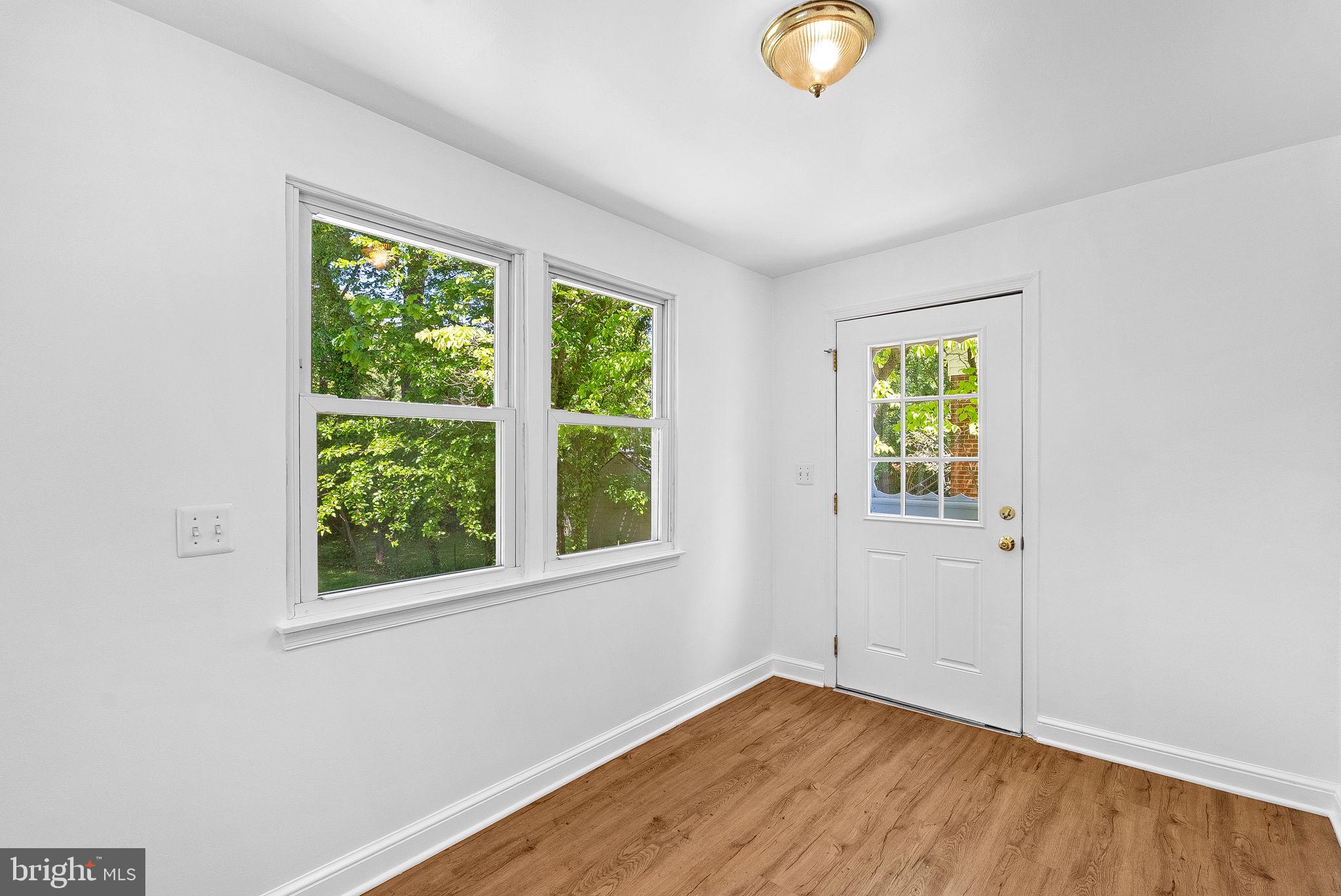 3103 Plyers Mill Road Kensington, MD 20895 - Photo 7 of 32 an empty room with wooden floor and windows