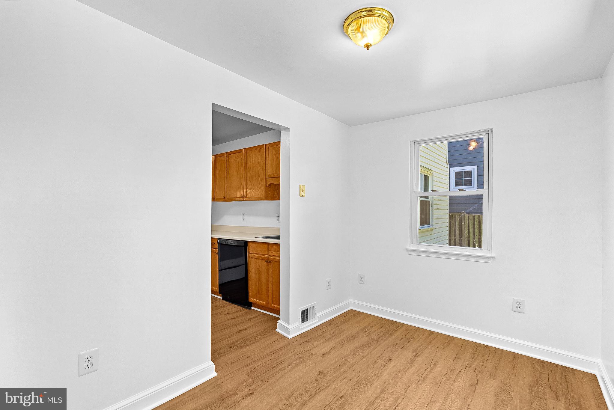 3103 Plyers Mill Road Kensington, MD 20895 - Photo 9 of 32 a view of an empty room with wooden floor and a window