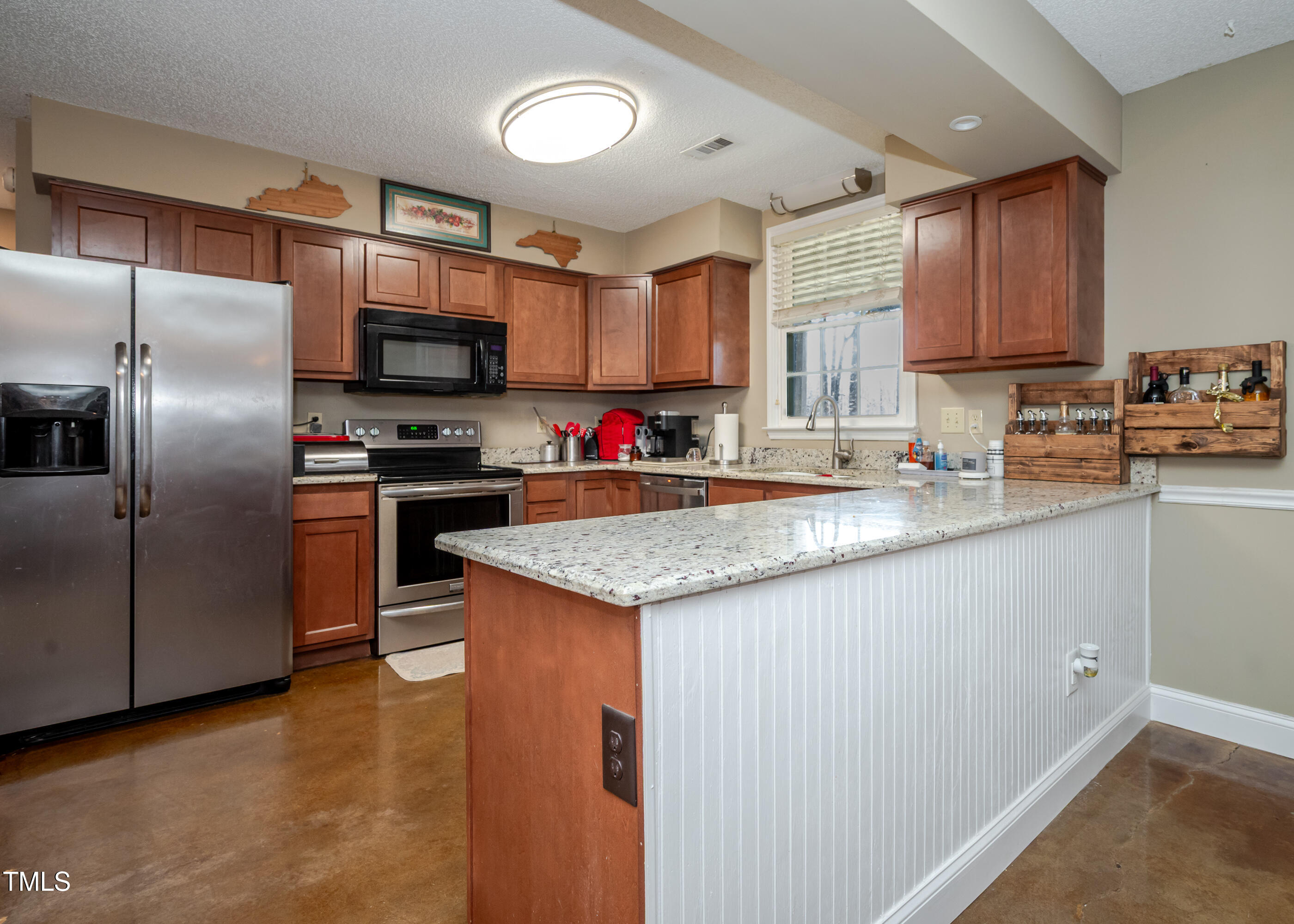 4105 Lassiter Road Wake Forest, NC 27587 - Photo 9 of 50 a kitchen with stainless steel appliances granite countertop a sink stove microwave and refrigerator