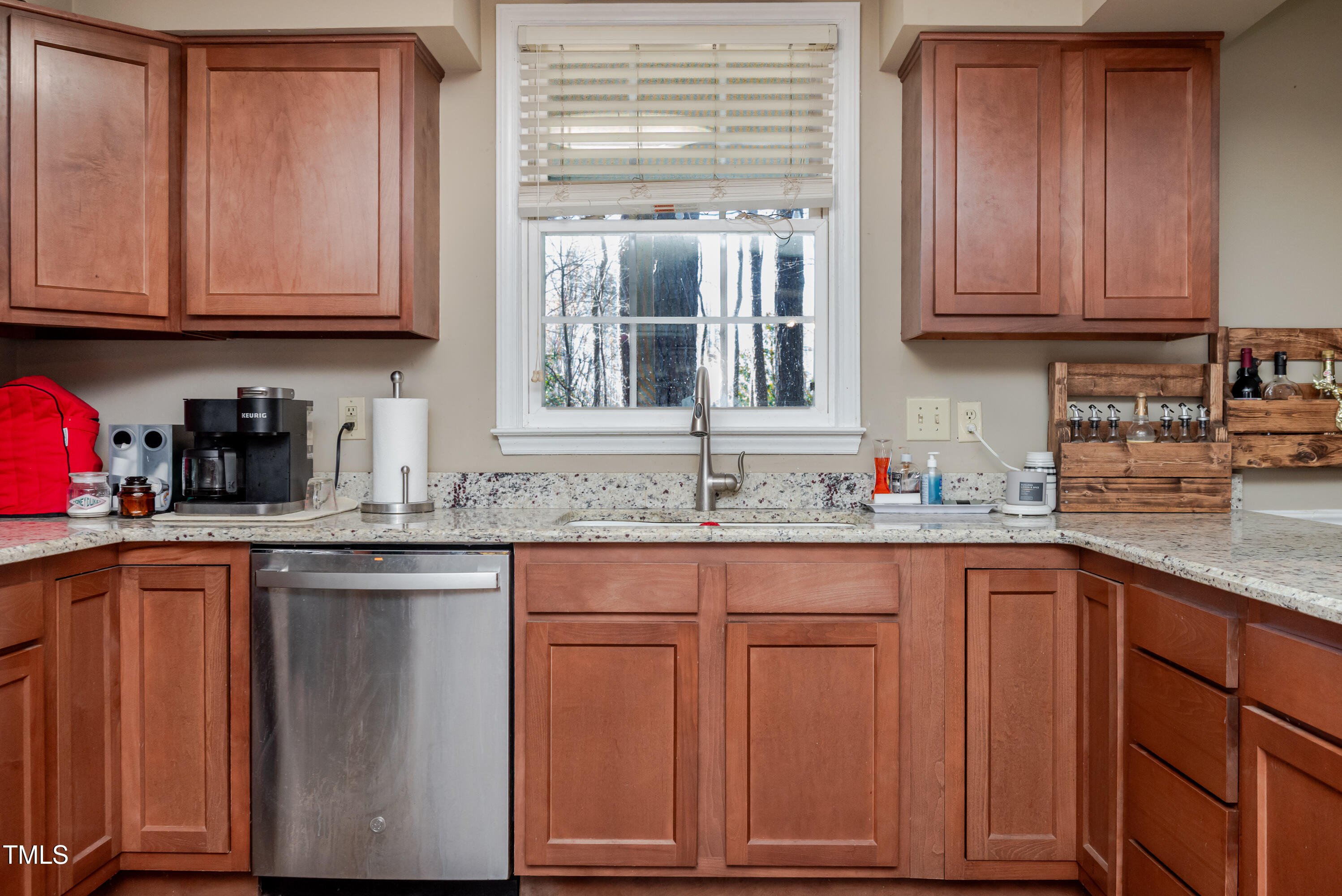 4105 Lassiter Road Wake Forest, NC 27587 - Photo 10 of 50 a kitchen with granite countertop stainless steel appliances white cabinets sink and dishwasher with wooden floor