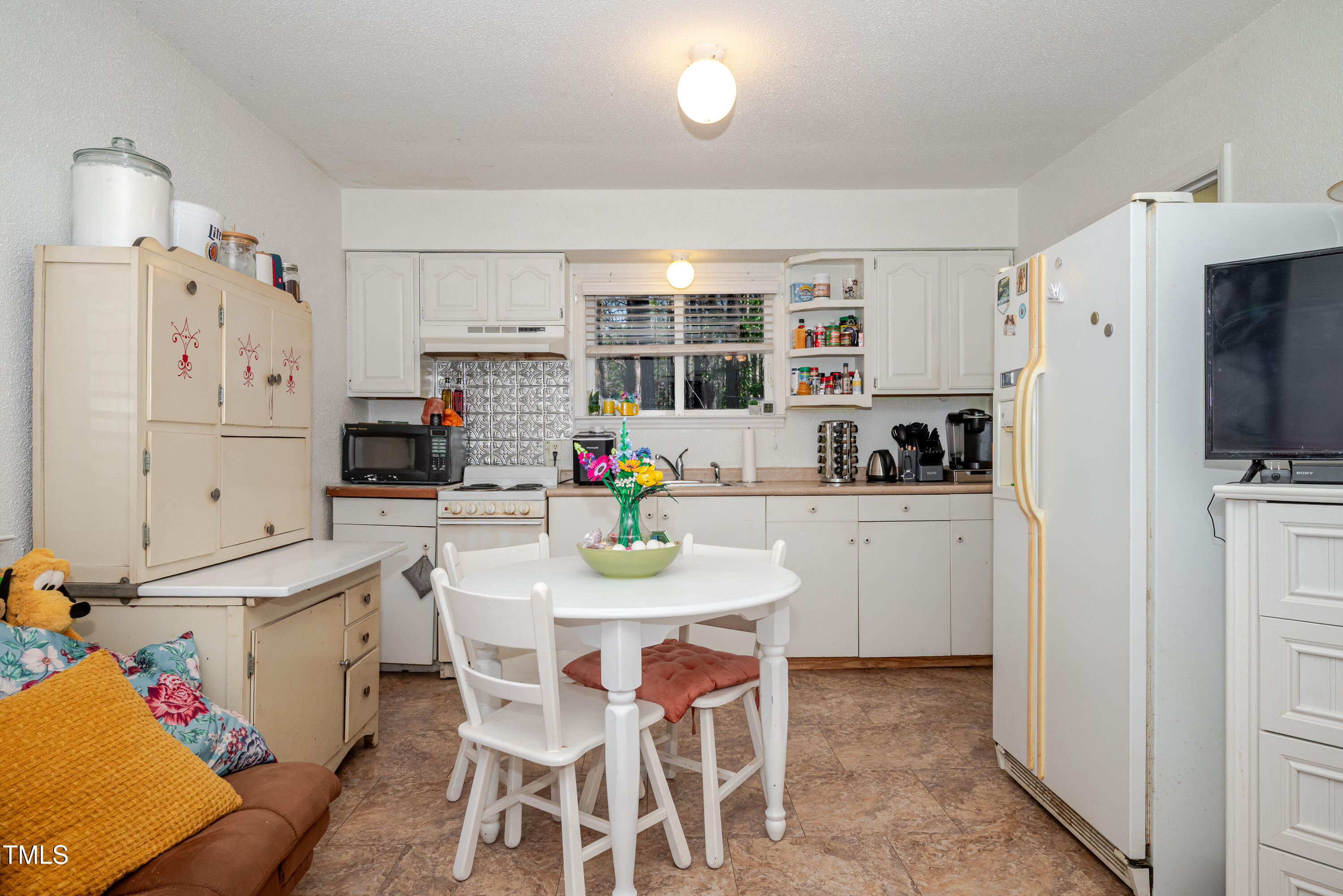 4105 Lassiter Road Wake Forest, NC 27587 - Photo 26 of 50 a kitchen with stainless steel appliances white cabinets and a refrigerator