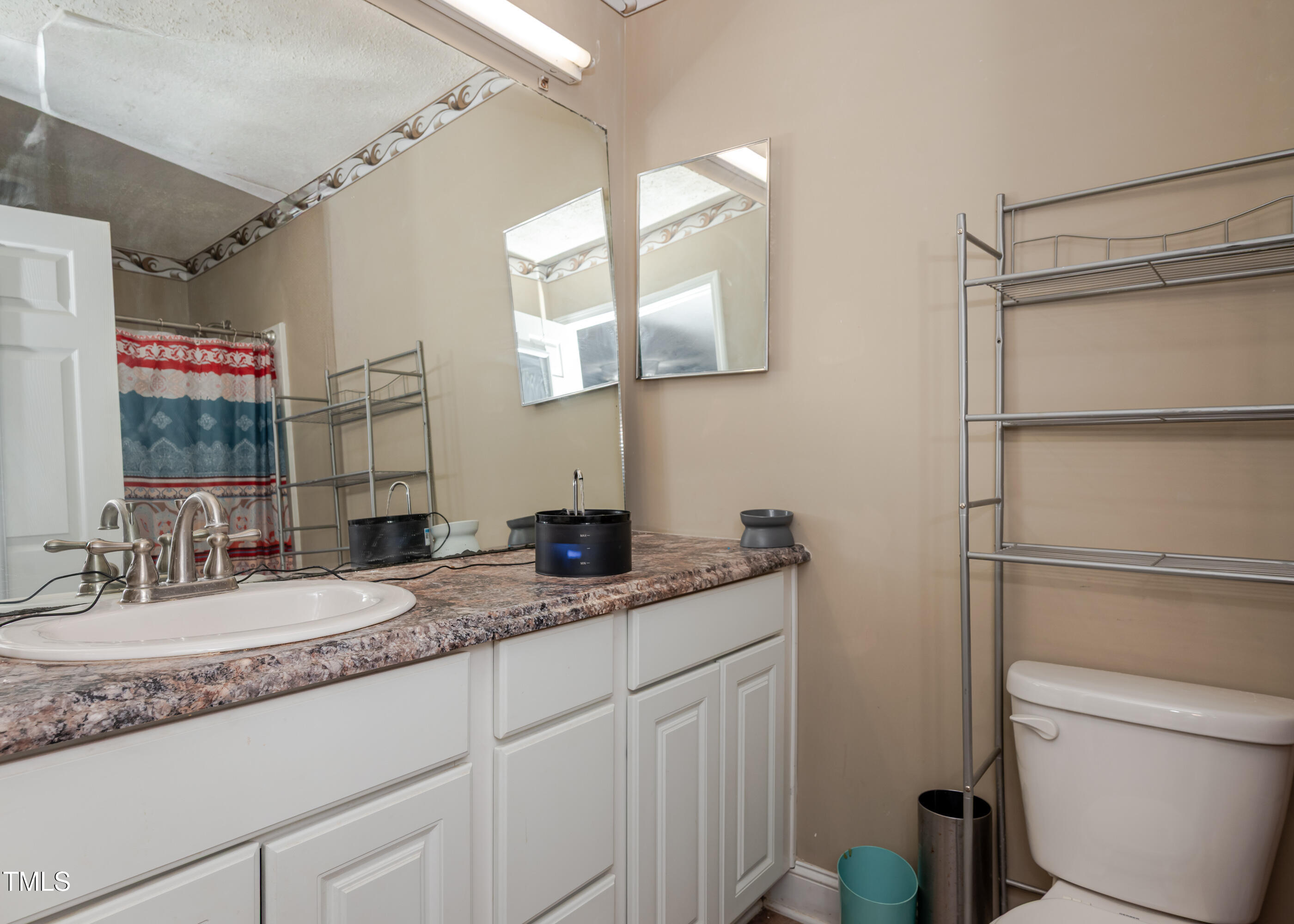 4105 Lassiter Road Wake Forest, NC 27587 - Photo 42 of 50 a bathroom with a granite countertop sink mirror vanity and toilet