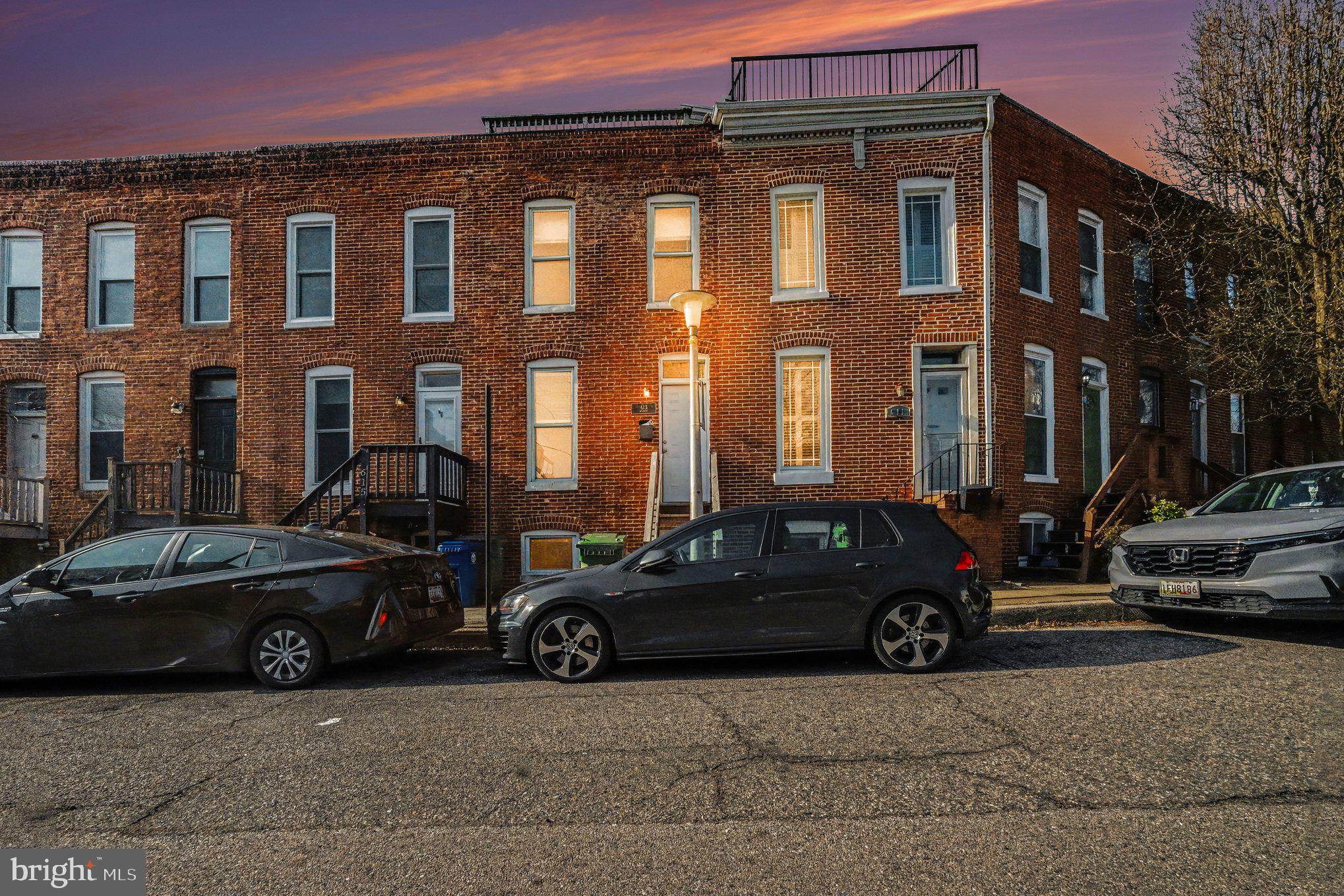 613 Harvey Street Baltimore, MD 21230 - Photo 2 of 33 Charming brick row homes at dusk.